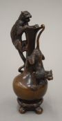 A patinated bronze decorative ewer modelled with wild cats. 15.5 cm high.