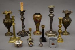 A quantity of various candlesticks, metal vases, etc.