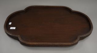 A Chinese carved wooden tray. 68 cm wide.