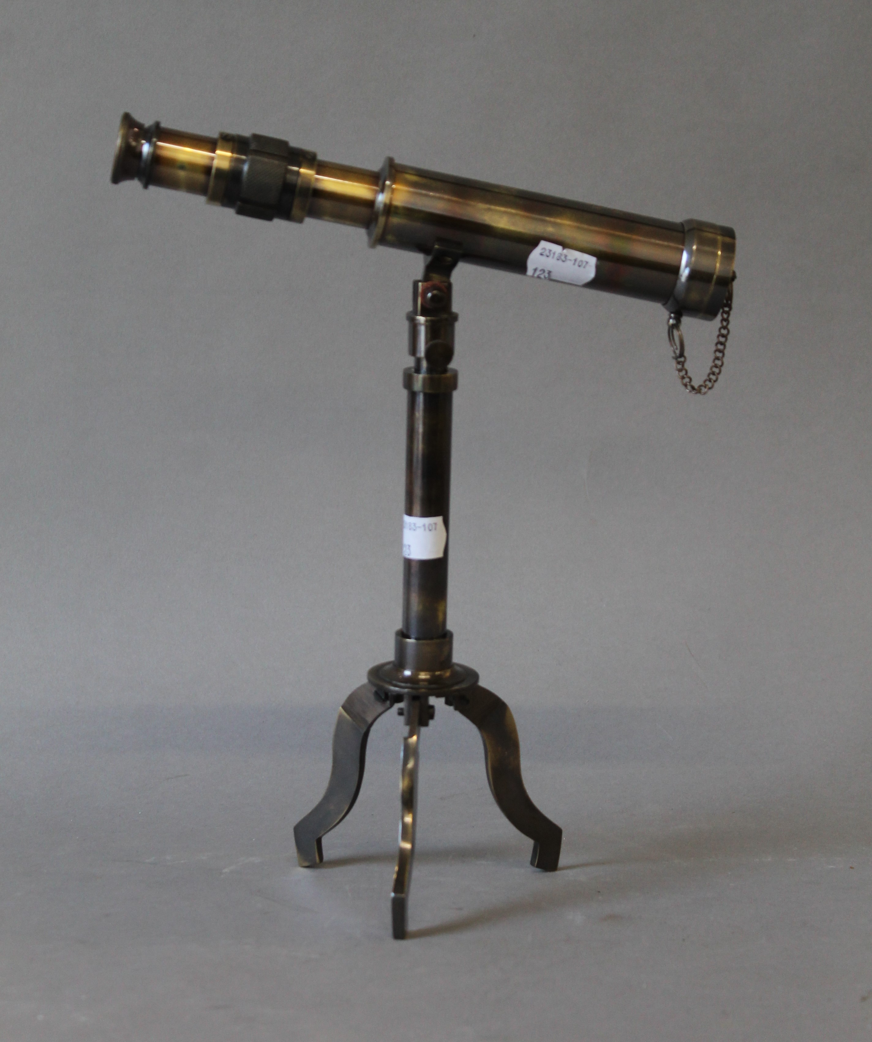 A small telescope on stand. 23.5 cm long.