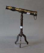 A small telescope on stand. 23.5 cm long.