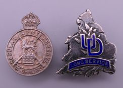 A silver UD (United Dairies) Long Service badge and a Regular Army Reserve of Officers badge.