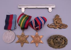A collection of medals World War II and military badges,