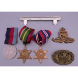 A collection of medals World War II and military badges,