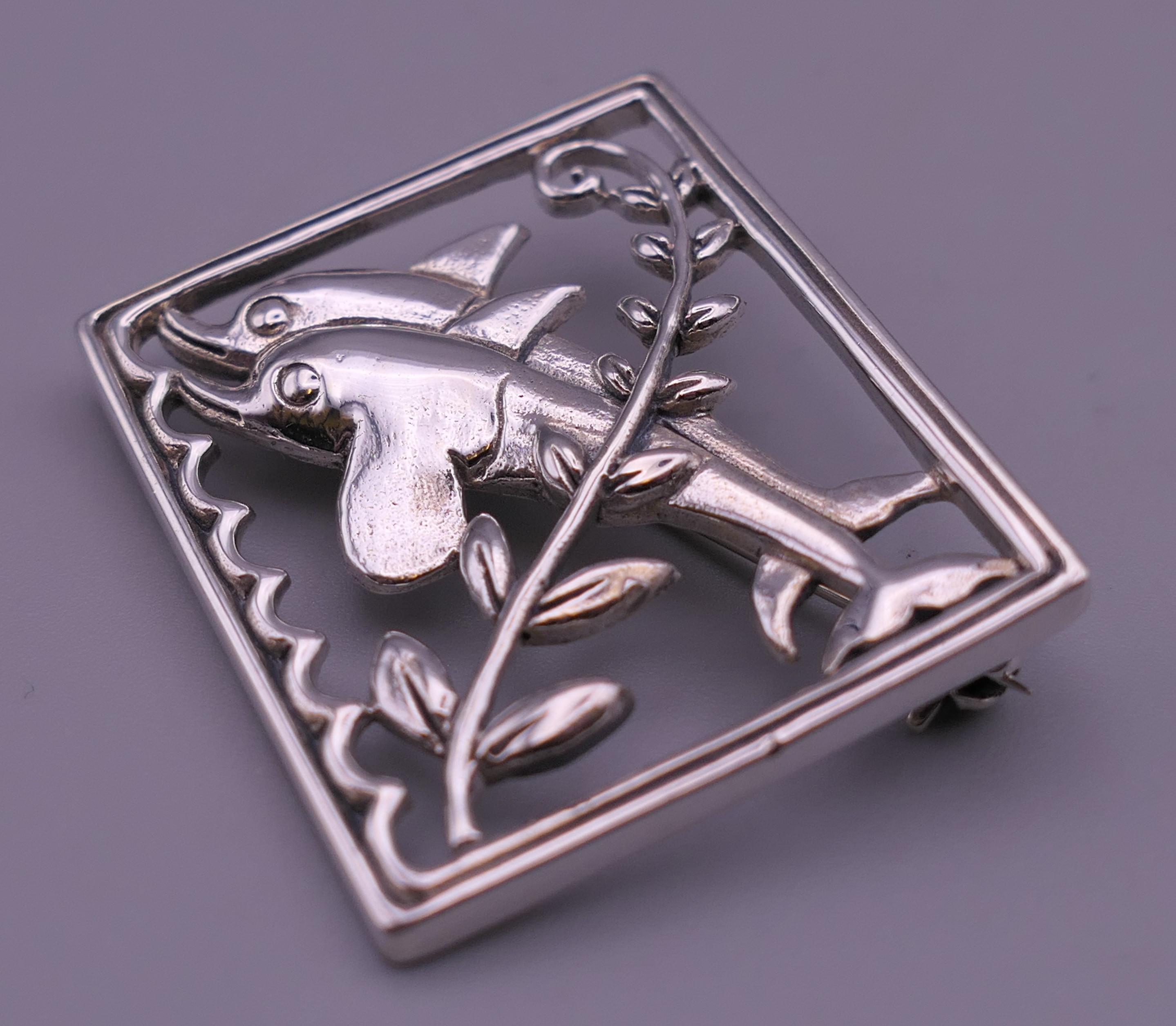A silver dolphin brooch. 3.5 cm x 2.75 cm. - Image 4 of 4