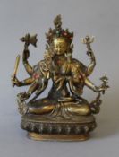 A bronze multi-armed deity decorated with coral. 21 cm high.