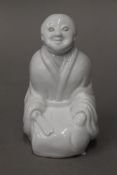 A 19th century Chinese blanc de chine figure. 11 cm high.
