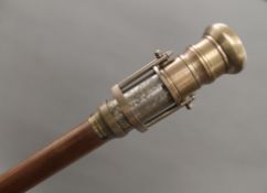 A walking stick with telescope/compass handle. 98.5 cm long.