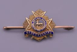 A 15 ct gold and enamel Bedfordshire military brooch, inscribed to reverse K to S, July 23 1918.
