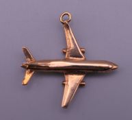 A 9 ct gold aeroplane form pendant. 2.75 x 2.75 cm. 3.2 grammes.