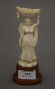 An early 20th century carved ivory Indian figurine on a wooden plinth base. 16.5 cm high.