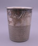 An unmarked silver novelty toddy cup in the form of an oversized thimble engraved 'Just a