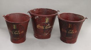 A set of three Coca-Cola buckets. The largest 32 cm high.
