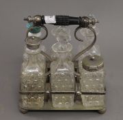 A silver plated cruet set. 18 cm wide.