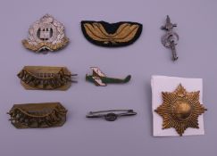 A collection of military badges (three for the Suffolk Regiment),