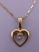 A 9 ct gold chain (1.5 grammes) with gold plated heart pendant. Pendant 1.