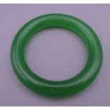 An apple green jade bangle. 5.75 cm internal diameter.