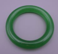 An apple green jade bangle. 5.75 cm internal diameter.