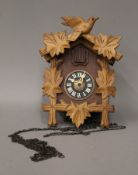 A vintage wooden cuckoo clock with two weights. 22 cm high.