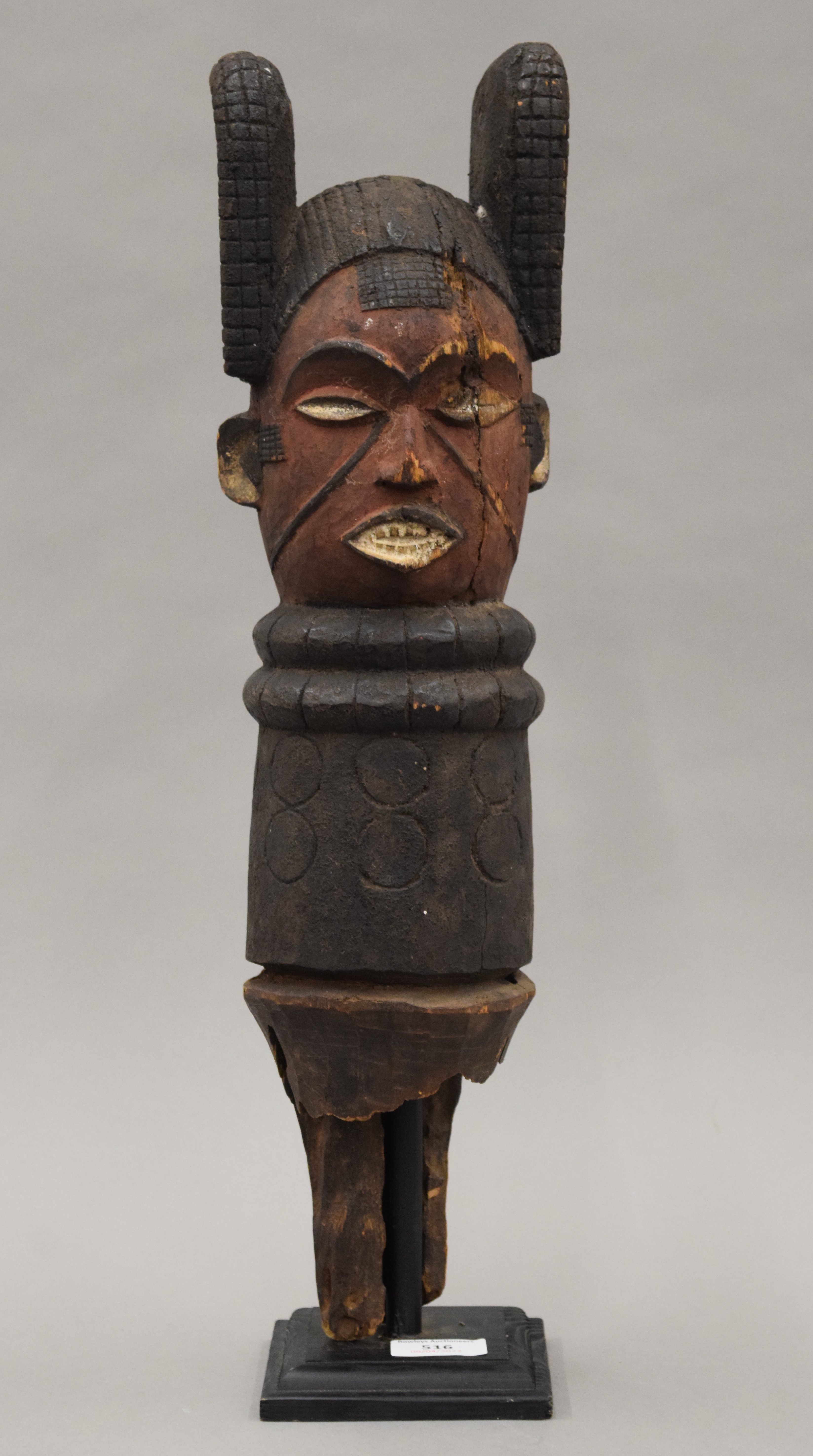 An African painted carved wooden tribal post, mounted on a display stand. 54 cm high overall. - Image 2 of 9