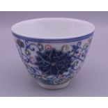 A Chinese Ducai porcelain tea bowl. 6 cm high.