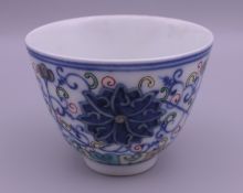 A Chinese Ducai porcelain tea bowl. 6 cm high.
