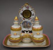A Victorian porcelain dressing table set and a porcelain clock. The latter 21 cm high.