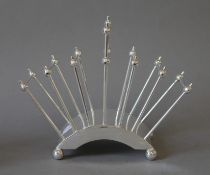 A Christopher Dresser style toast rack. 21.5 cm wide.