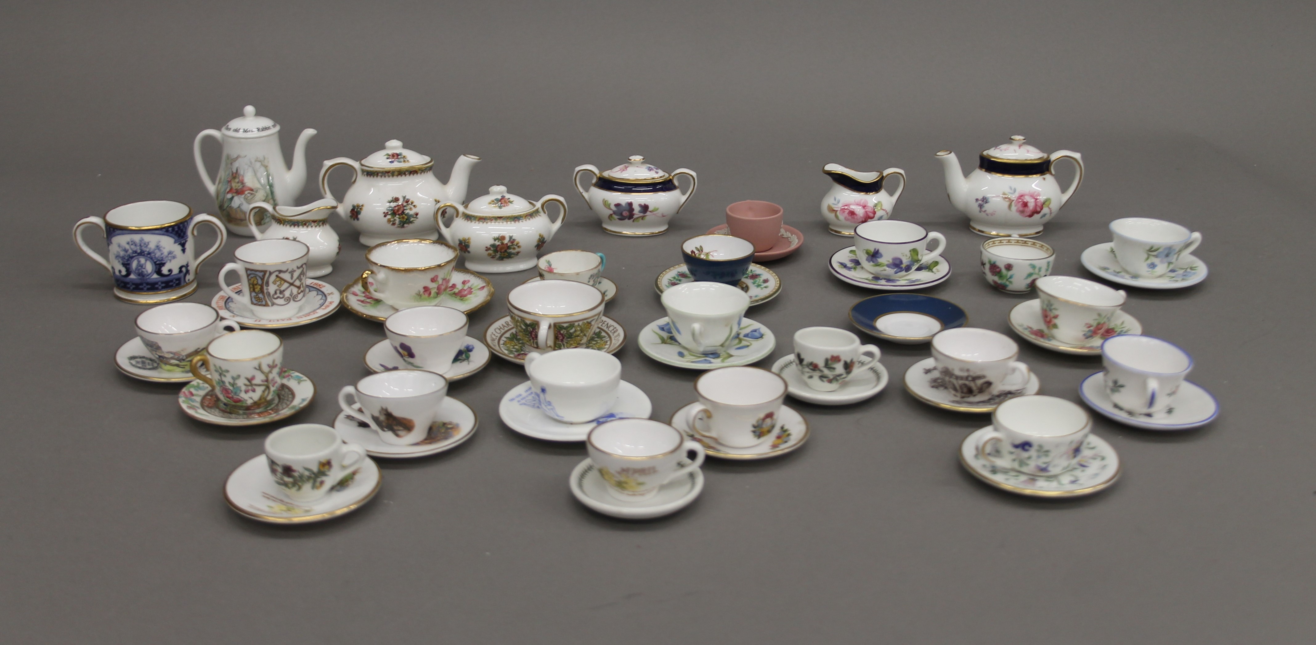 A collection of porcelain miniatures, including Royal Crown Derby, Wedgwood, etc.