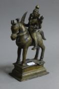 An Indian bronze figure of a deity riding a horse. 21 cm high.