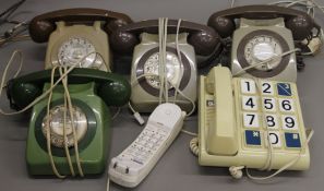 A box of various vintage telephones.