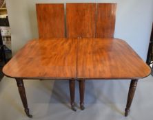 An early 19th century mahogany extending dining table with three additional leaves (in the manner
