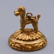 A 9 ct gold poodle form fob pendant. 2.5 cm high. 11.7 grammes total weight.