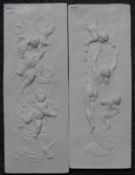 A pair of plaques decorated with cherubs. 47 cm high.