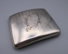 A silver cigarette case. 10.5 cm x 8.5 cm. 190.5 grammes total weight.