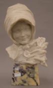 A carved marble bust of a young girl and wheat sheaves, mounted on a marble base. 49 cm high.