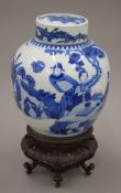 A 19th century Chinese porcelain ginger jar mounted on a wooden stand.