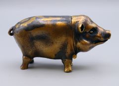 A brass vesta in the form of a pig. 6 cm long, 3 cm high.