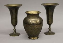 Three Cairoware type brass vases. The smallest 17.5 cm high.