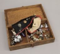 A box of military and fire brigade buttons, etc.