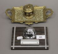 A brass inkwell and another inkwell. The former 23 cm wide.
