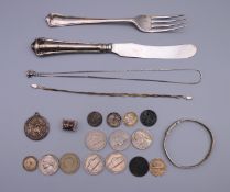 A quantity of various silver, including coins, knife and fork, St Christopher pendant, etc.