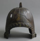 A Chinese bronze helmet. 30 cm high.
