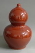 A large Chinese porcelain red ground double gourd vase. 45 cm high.