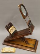 A large Victorian stereo graphoscope with stereo cards. 55 cm long.