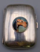A silver cigarette case centred with dog's head portrait. 8 cm x 6 cm.