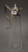 A silver plated mounted engraved glass claret jug. 31 cm high.