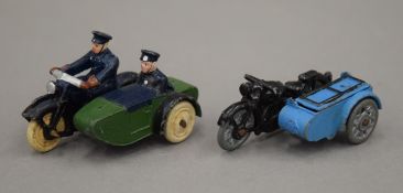 A toy motorbike and sidecar with RAC logo on front of sidecar with a hinged top,