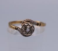 A platinum and 9 ct gold diamond ring. Ring size L/M. 2 grammes total weight.