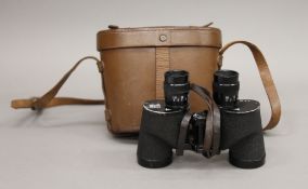 A pair of Bausch and Lomb WWII 6x30 binocular field glasses with original leather strap and in